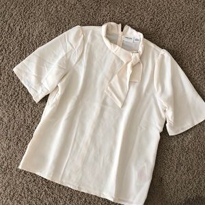 Worn once. Short sleeve blouse with neck tie.